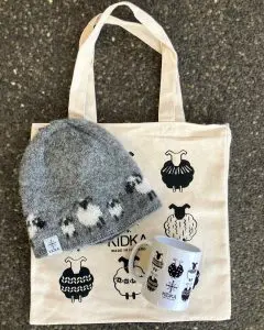 This Kidka Sheep Gift Set includes a charming Kidka sheep cup, a cozy sheep beanie made from Icelandic wool in Iceland, and a free sheep tote bag.