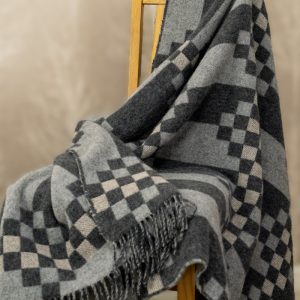 Inspired by the natural beauty of basalt columns and their unique natural tones, this bed and sofa cover creates a striking visual illusion. Shift your focus slightly, and the woven pattern reveals a remarkable 3D effect. Leftover cut-offs and wool remnants from our own production were shredded, blended with soft merino lambswool, and spun into new yarn — Creating a unique blend of 40% Recycled Icelandic Wool and 60% Merino Lambswool