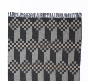 Inspired by the natural beauty of basalt columns and their unique natural tones, this bed and sofa cover creates a striking visual illusion. Shift your focus slightly, and the woven pattern reveals a remarkable 3D effect. Leftover cut-offs and wool remnants from our own production were shredded, blended with soft merino lambswool, and spun into new yarn — Creating a unique blend of 40% Recycled Icelandic Wool and 60% Merino Lambswool
