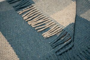 The Summer/Winter weaving pattern shows two contrasting sides—one light, one dark. In this blue and beige version, it reflects the summer season, where bright blue skies stretch over sunlit landscapes. The woven tones capture the warmth, light, and gentle energy of long summer days. Leftover cut-offs and wool remnants from our own production were shredded, blended with soft merino lambswool, and spun into new yarn - Creating a unique blend of 40% Recycled Icelandic Wool and 60% Merino Lambswool The yarn was then woven into covers Cover measurements: 130 cm x 180 cm 51.18 inches x 70.87 inches