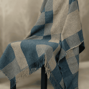 The Summer/Winter weaving pattern shows two contrasting sides—one light, one dark. In this blue and beige version, it reflects the summer season, where bright blue skies stretch over sunlit landscapes. The woven tones capture the warmth, light, and gentle energy of long summer days. Leftover cut-offs and wool remnants from our own production were shredded, blended with soft merino lambswool, and spun into new yarn - Creating a unique blend of 40% Recycled Icelandic Wool and 60% Merino Lambswool The yarn was then woven into covers Cover measurements: 130 cm x 180 cm 51.18 inches x 70.87 inches