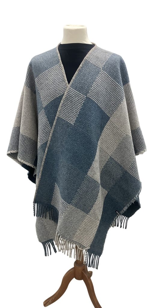 KIDKA ReCover summer/winter blue is a woven warm, sturdy and elegant wool poncho. Easy to wear & the soft, durable material keeps you warm on cooler days. Icelandic wool & Merino